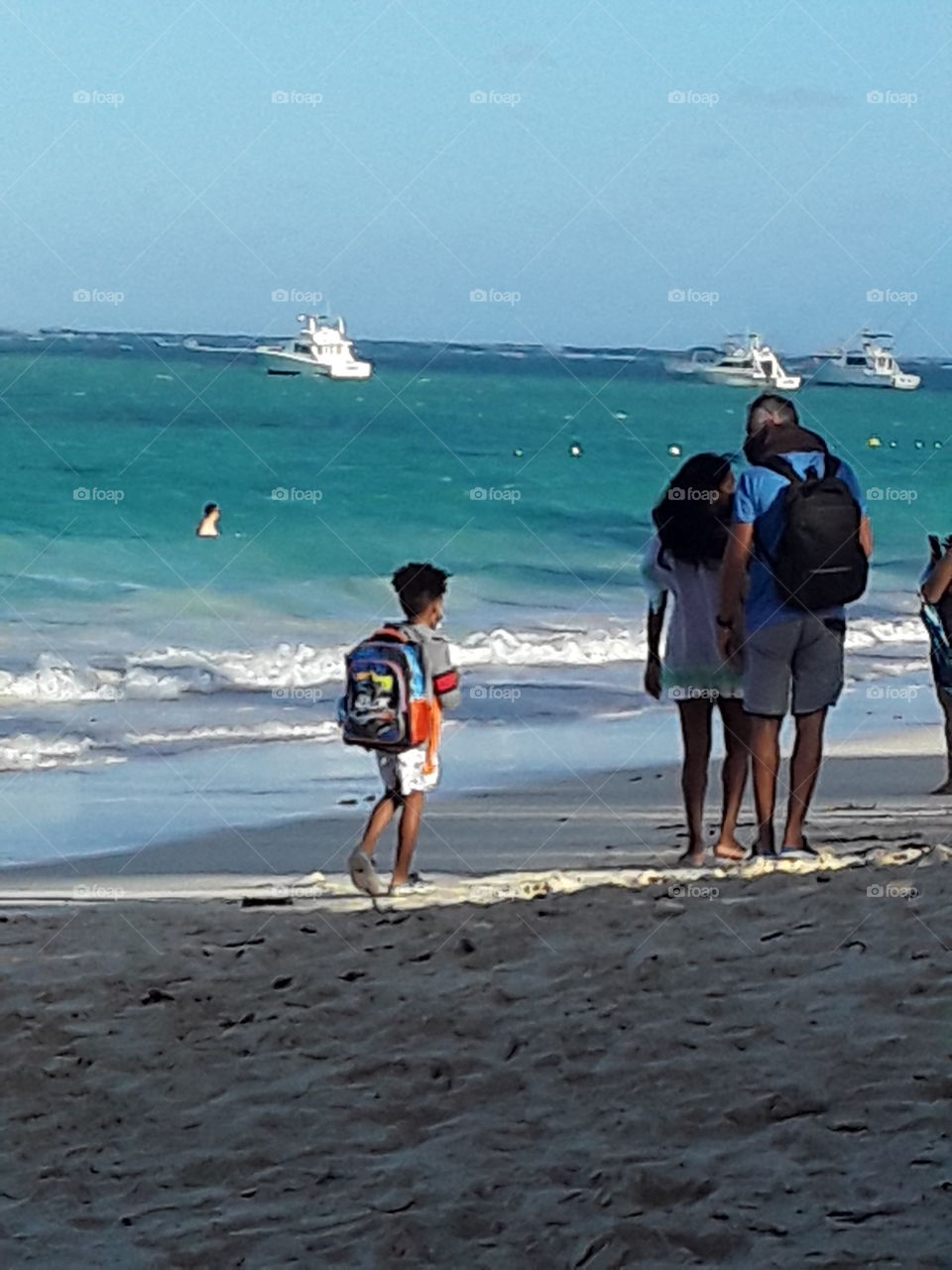 family walks along the beach in the Dominican Republic