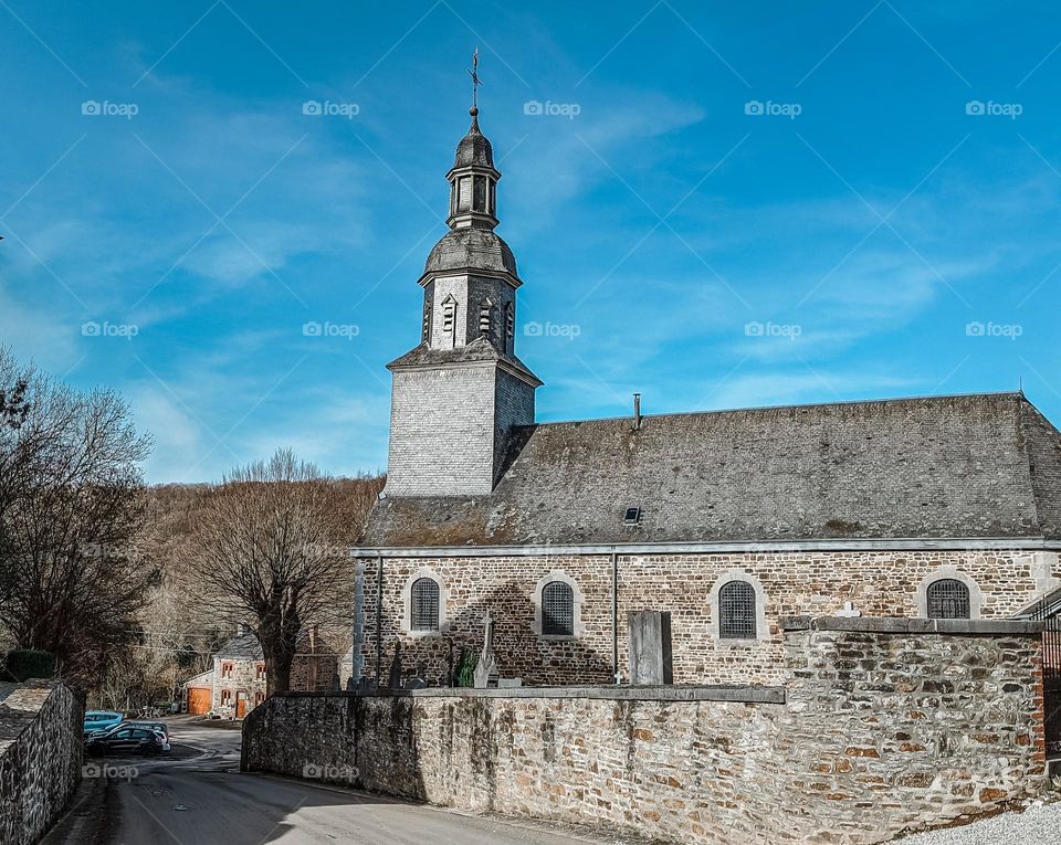 Beautiful view of the ancient stone catholic church in Masbourg, Belgium, close-up side view. The concept of historical buildings.