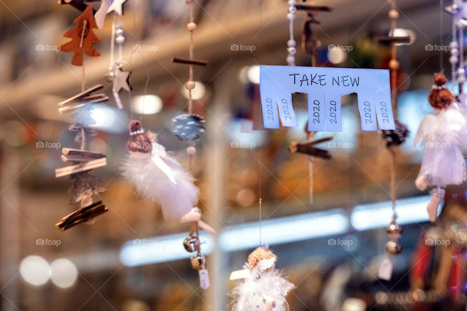 Christmas shop window with paper with the phrase: Take New and with a 2020 sign ready to be tore off