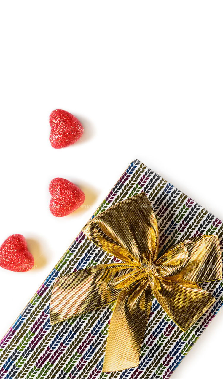 Gift with red hearts on a white background.