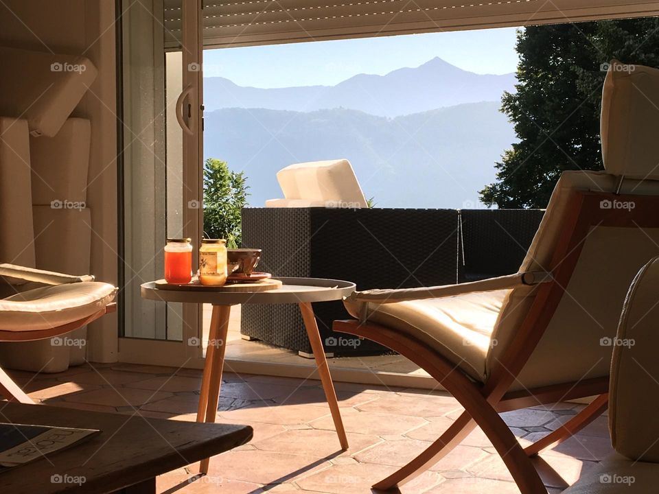 Lovely spot at home for breakfast with open window on mountainous landscape 