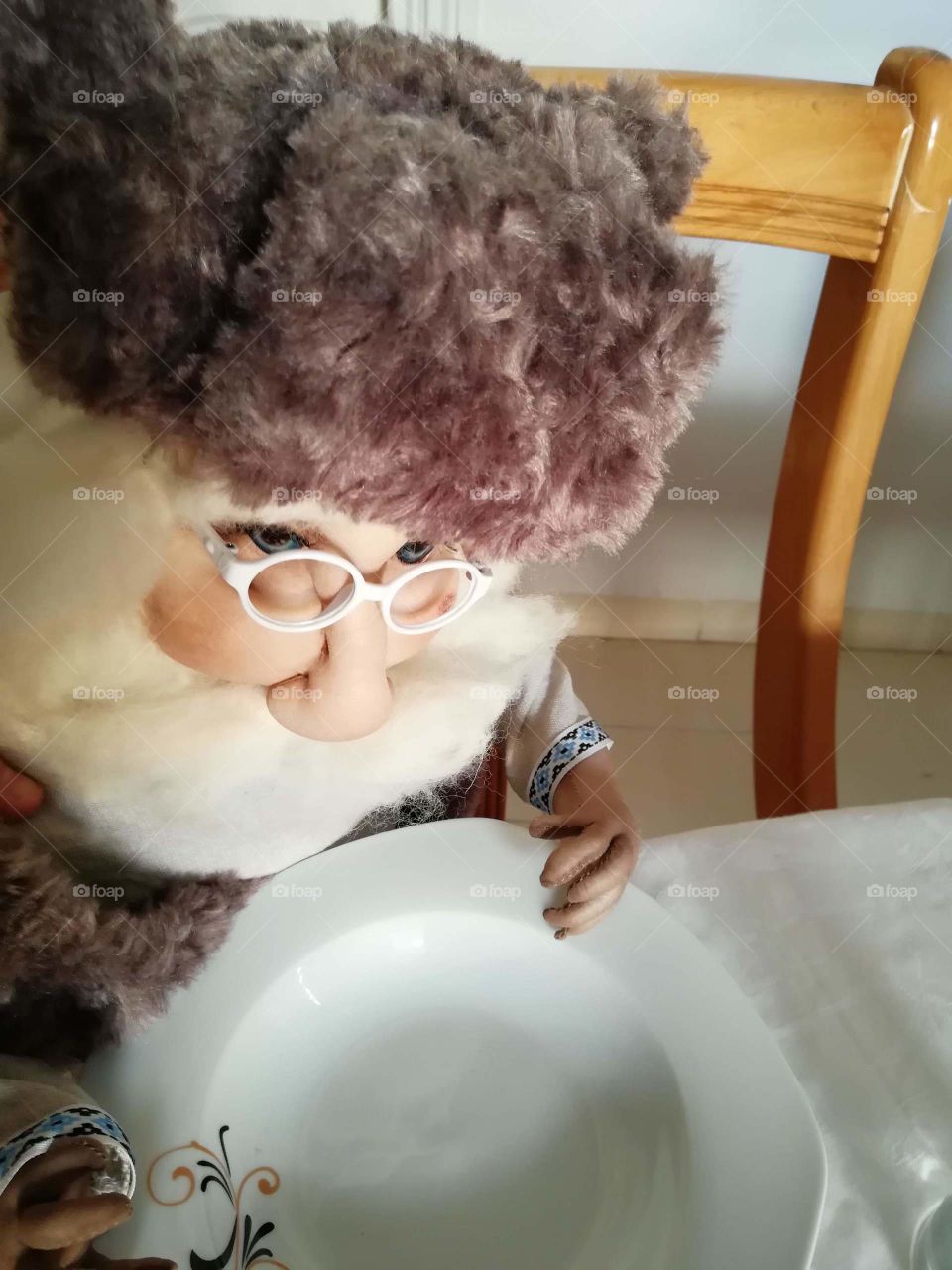 Doll waiting at dinner