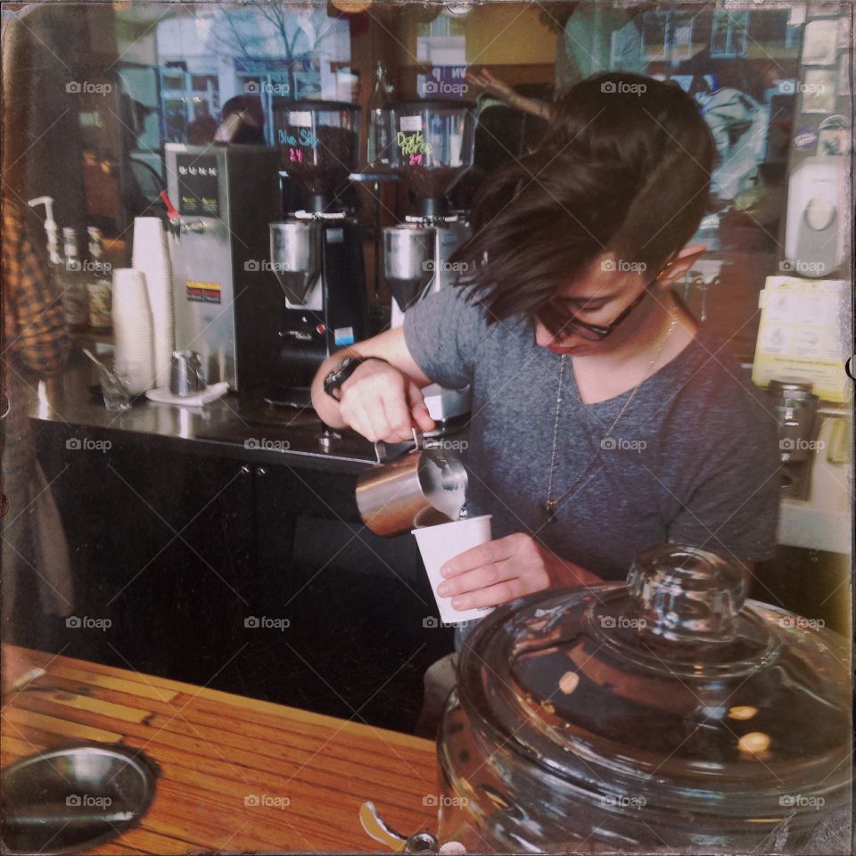 The pour. Barista pouring a latte