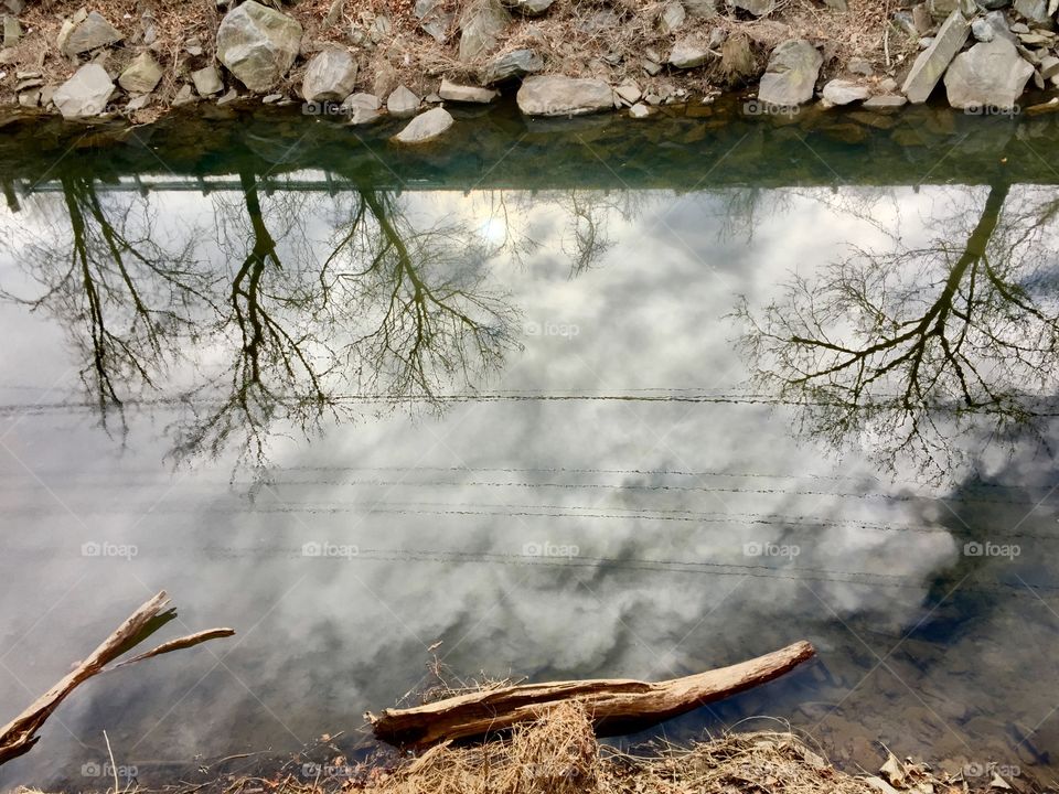 Reflections of the sky in the Pennypack creek from a railroad bridge 