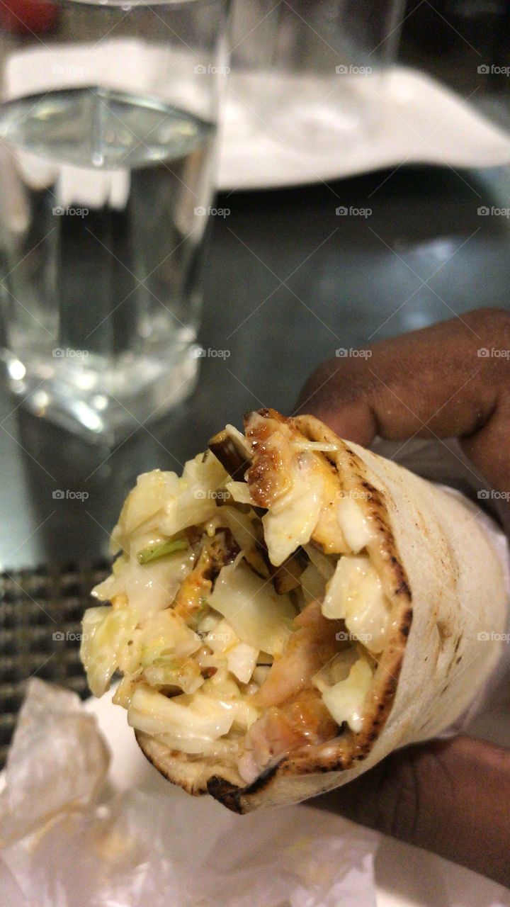 Eating delicious chicken shawarma 