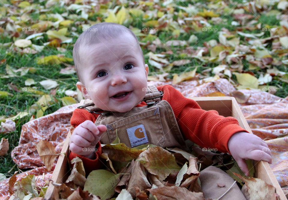 baby and fall leaves