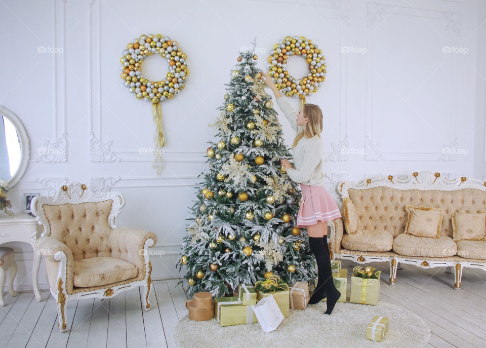 girl decorates the Christmas tree