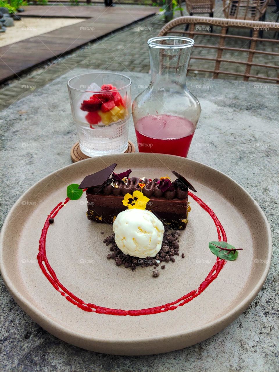Chocolate cake with ice cream and strawberry sauce