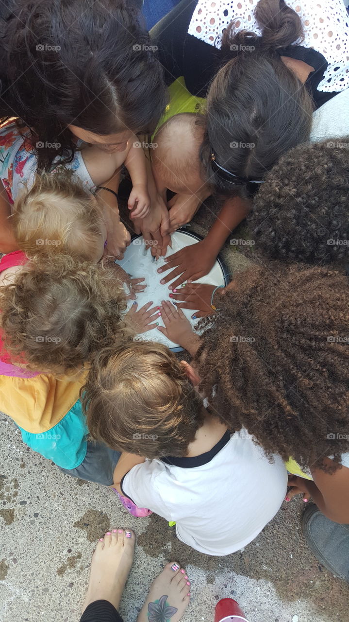 handprints. six cousins making a handprint cast for their great grandparents