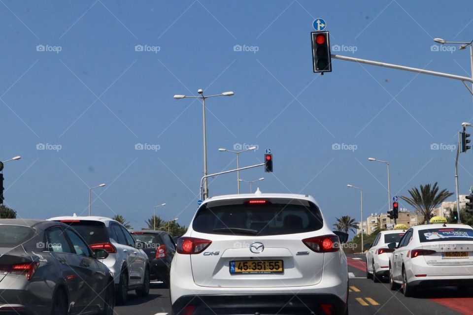 Cars stop on red traffic light 