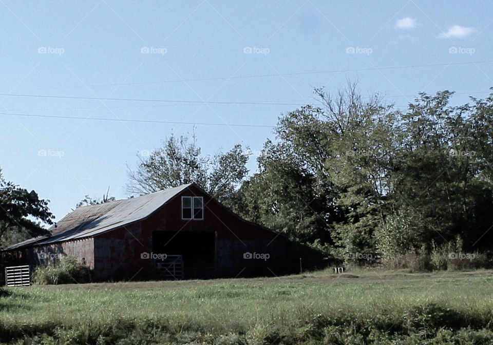 An old red barn along a country highway. 