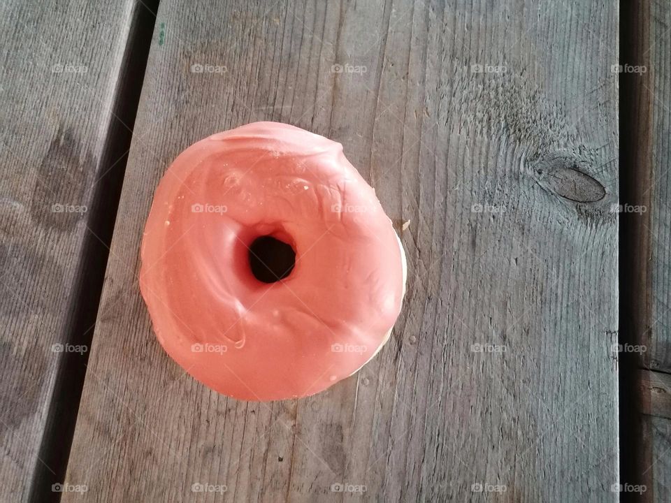 One donat on the wooden table