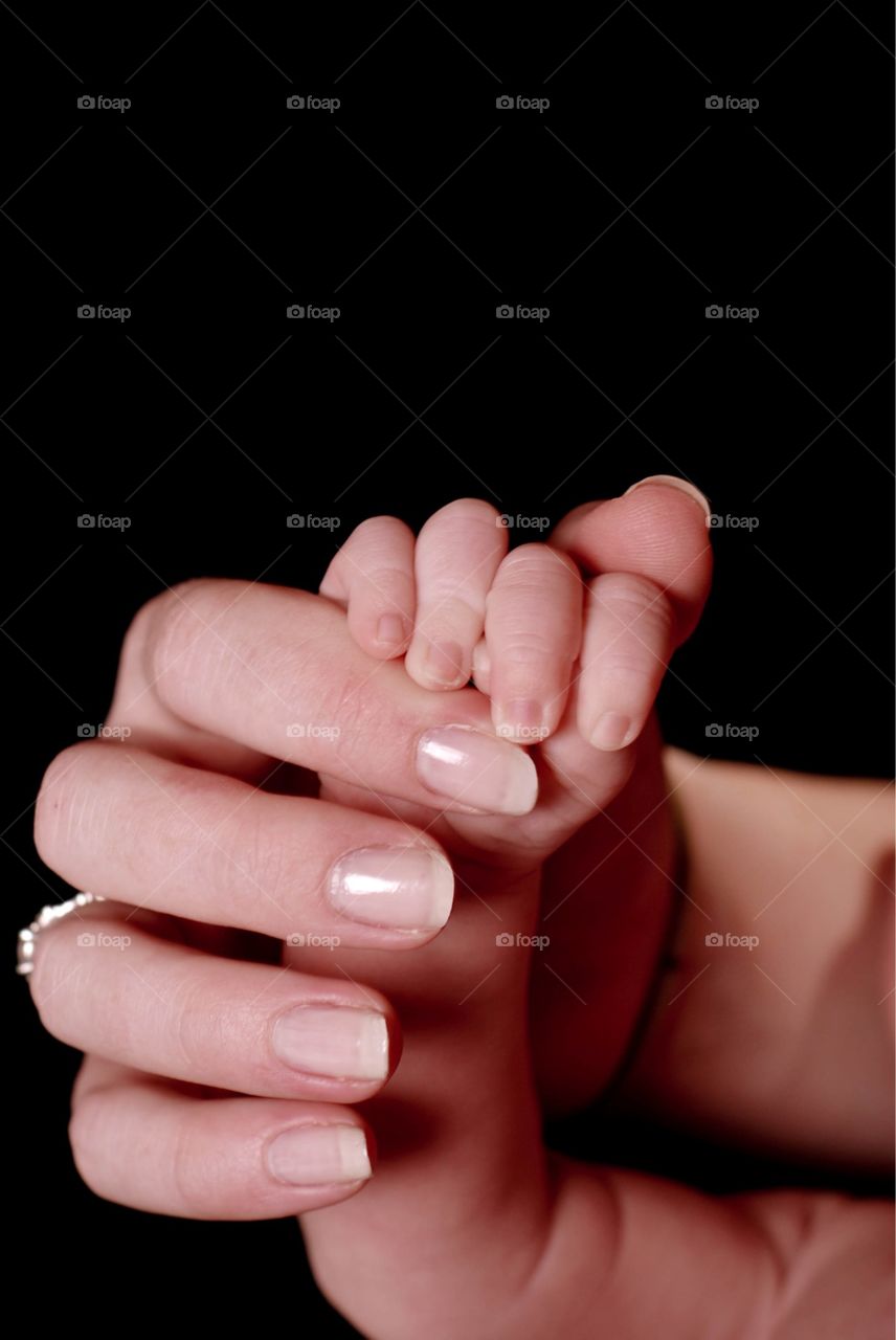 Mother holding baby's hand