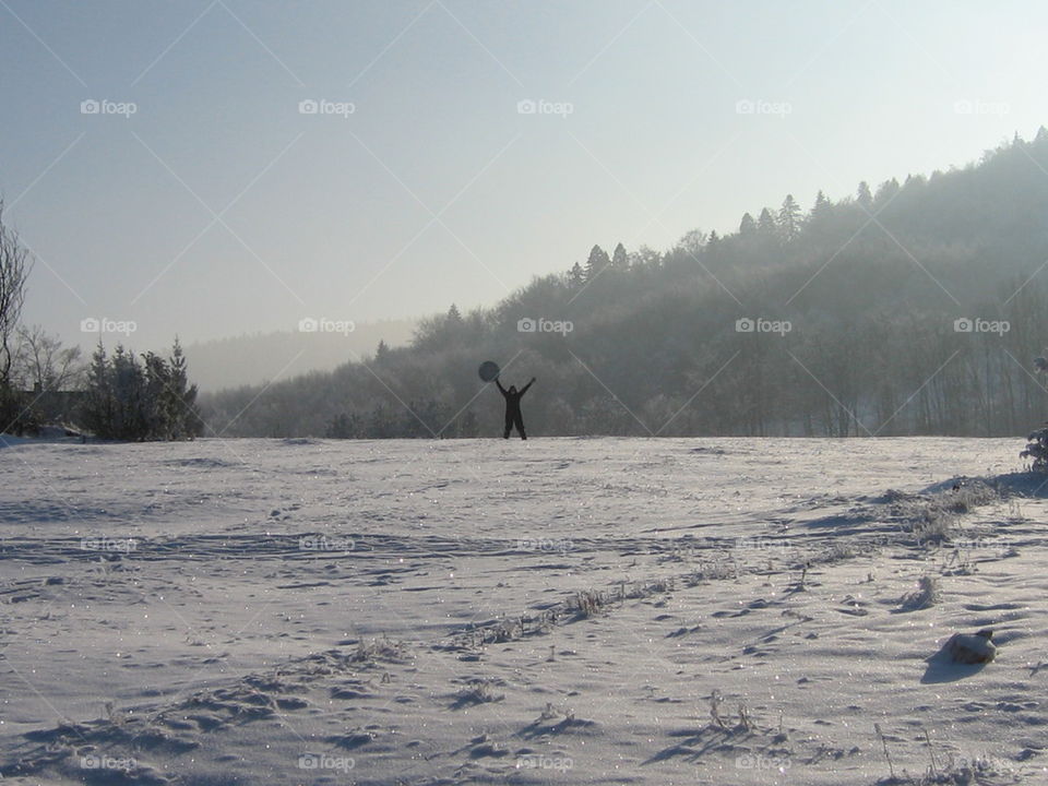 woman waveing accross lot of snow