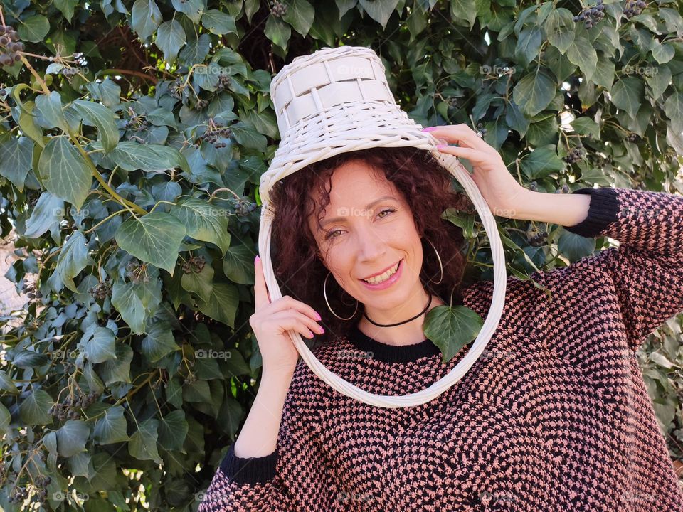 Funny Portrait of Young Woman Posing With Basket on Head, Smiling with Happy Face