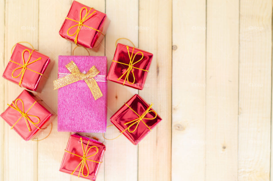 Red Gift box on wood background.