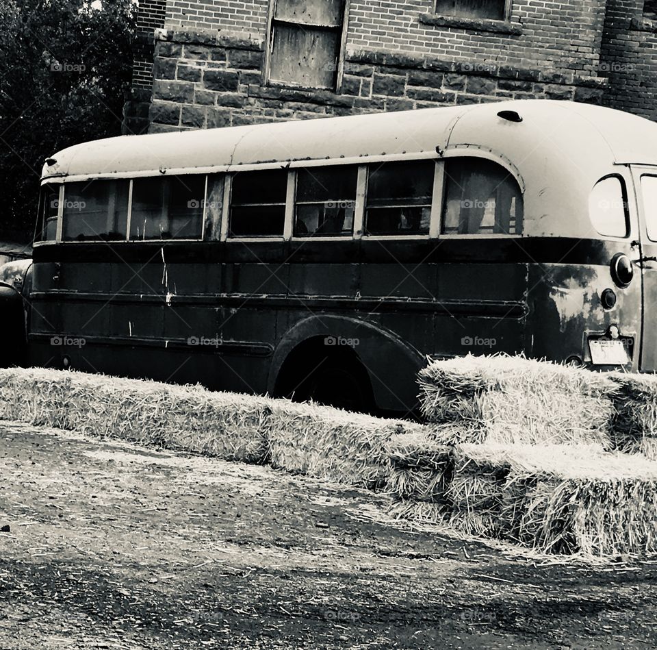 An old creepy rundown bus in black and white 