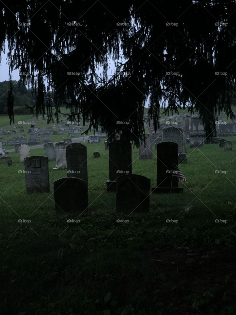 Headstones at the cemetery on a rainy day