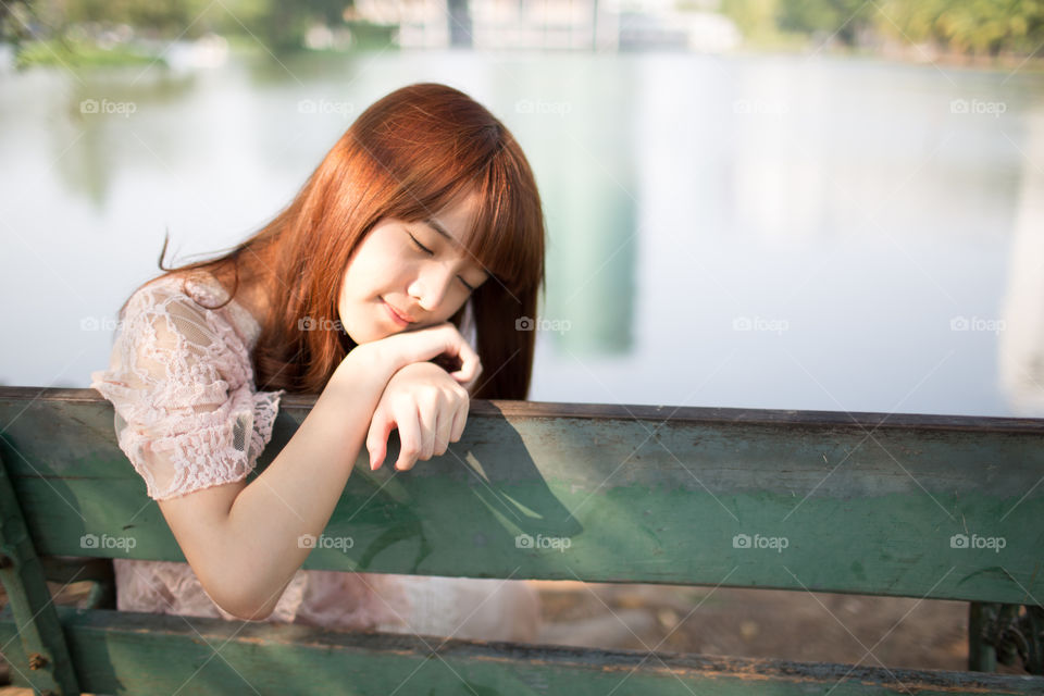 Young cute girl sleeping in the park 