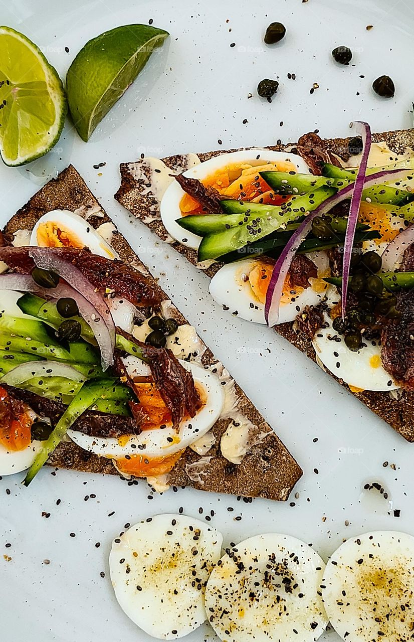 Anchovy eggs sandwiches with cucumber and lime