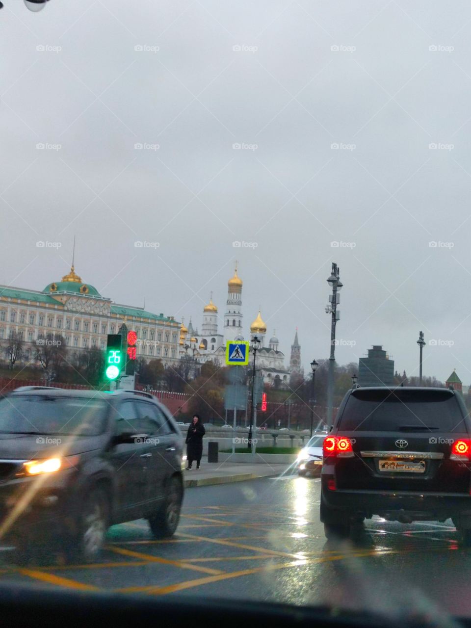 Evening roads of Moscow.  The buildings of the Grand Kremlin Palace and the Ivan the Great Bell Tower are visible in the background