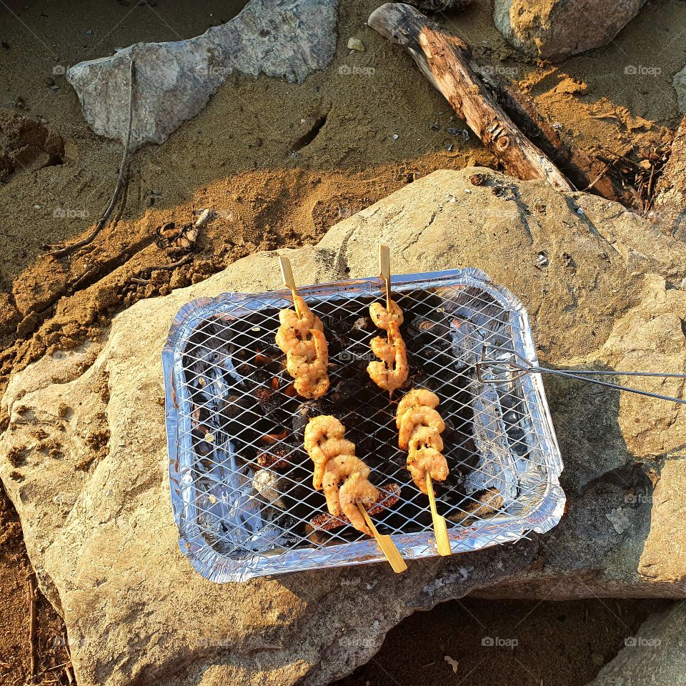 Tasty shrimps from a wooden skewer.