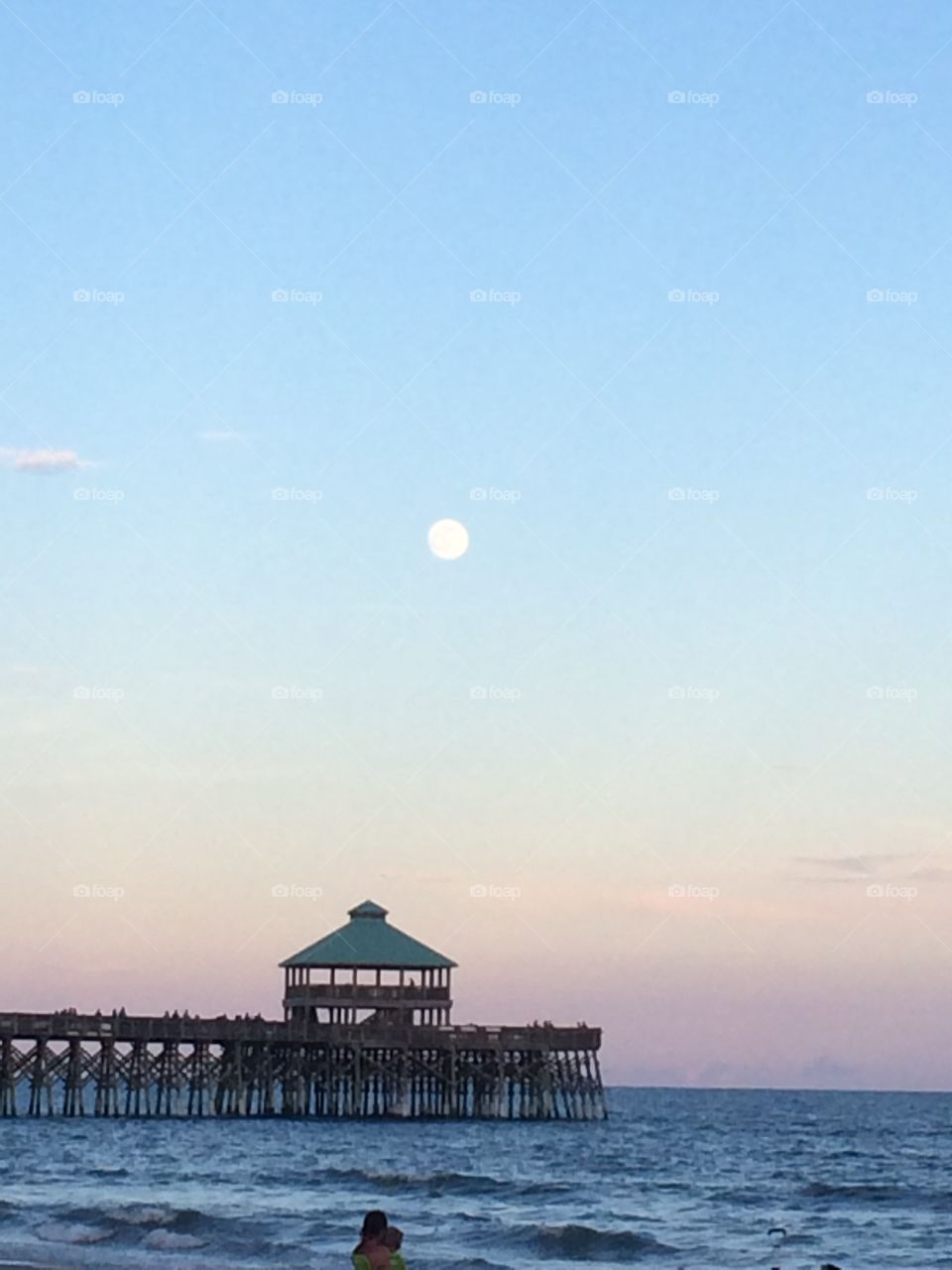 Moon, Pier, and Ocean at Sunset