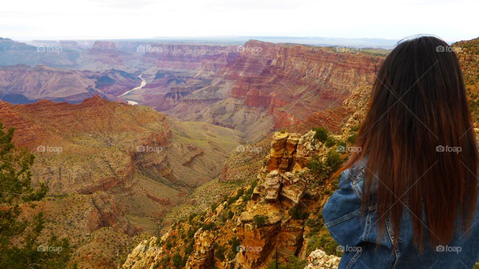 Woman is looking the Grand Canyon a Cloudy day