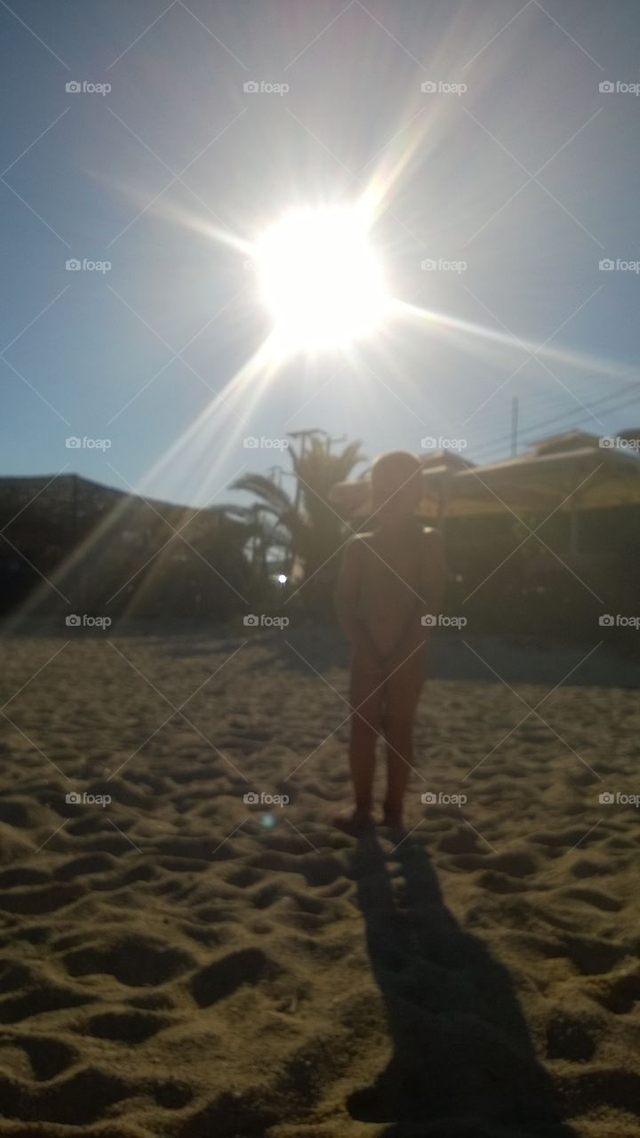 Sunny Kalamitsi beach Greece. Little boy standing on the beach