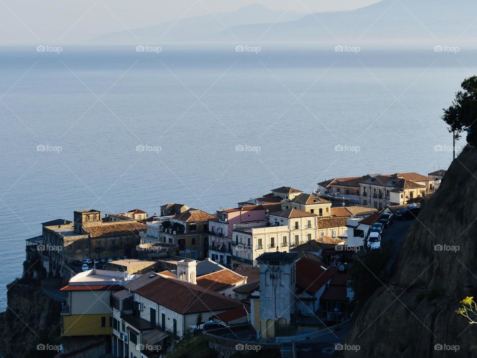 Houses illuminated by the sunrise near the sea