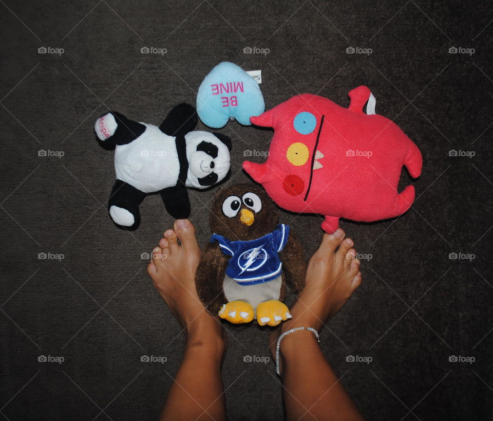 My feet and my stuffed animals on the floor