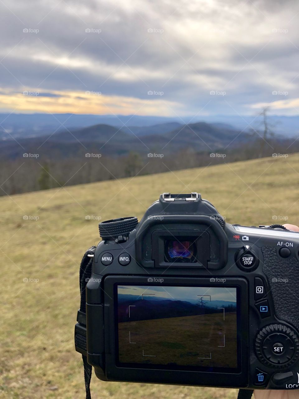 Mountain scene in and out of a camera screen