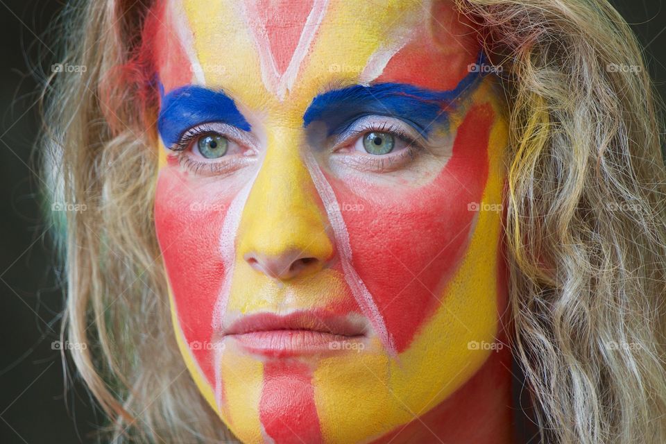 An artistically painted face of a woman at the Annual Body Painting Day in  New York City.