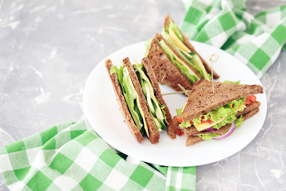 Tasty sandwiches on grey background. Delicious food