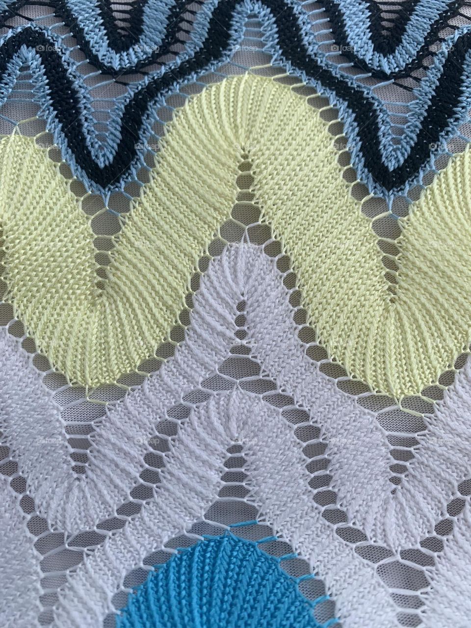 Closeup image of patterned multi coloured knitted material