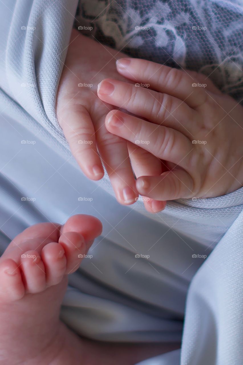 Close up of baby hands and feet 