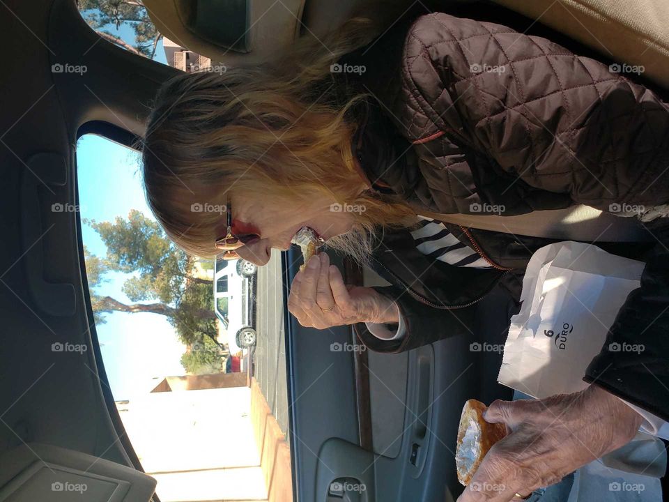 mom (88) eating the cream out of a cream puff. finger licking good