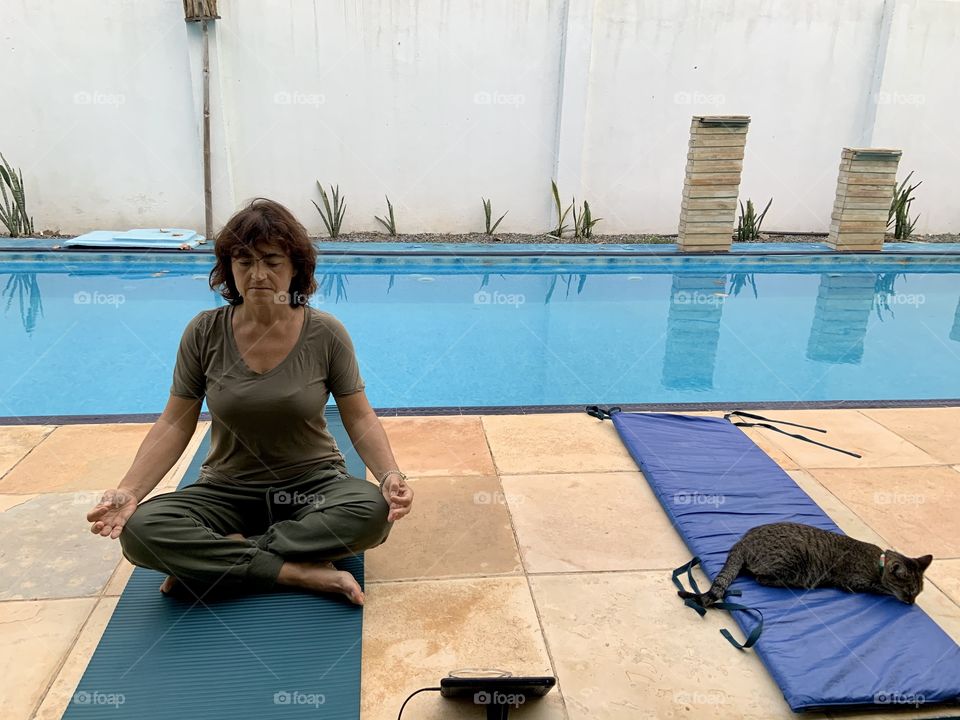 Yoga on line near swimming pool 