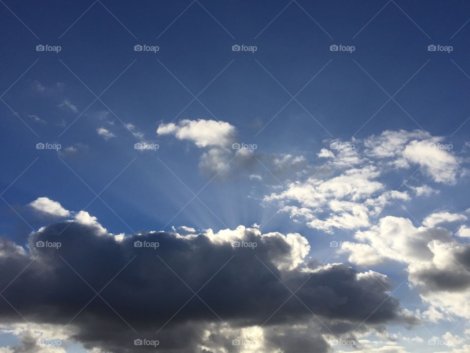 The rays of sun coming through the grey cloud