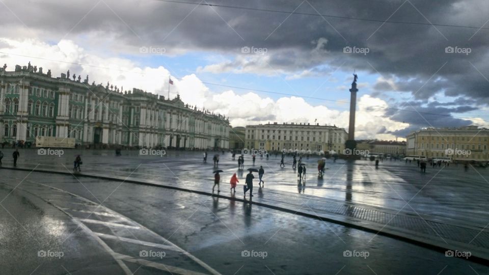 Rain on the city square, St. Petersburg.  People walk under umbrellas