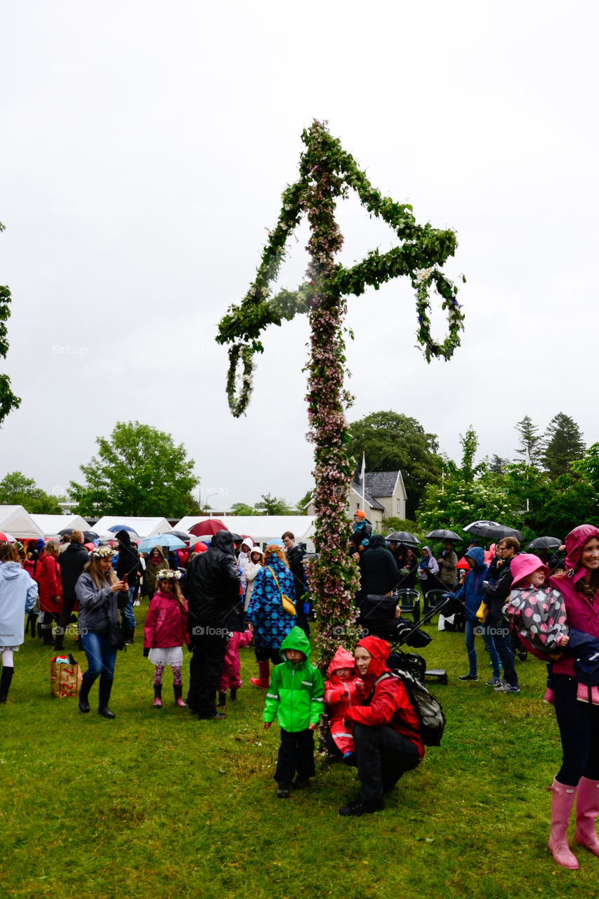 Swedish people is celebrating midsummer in the rain.