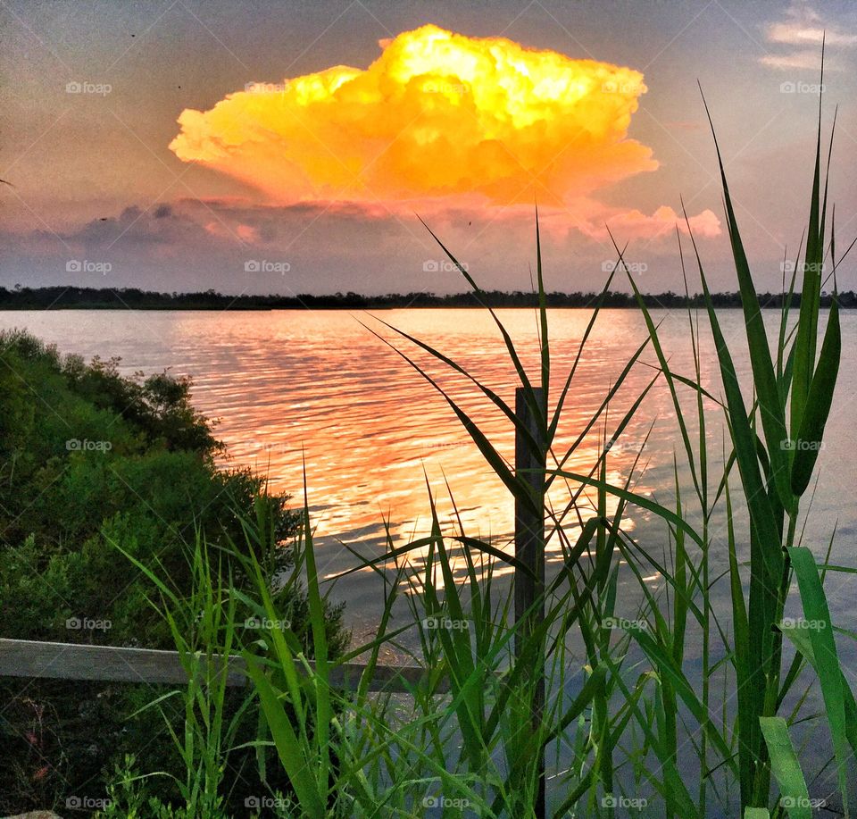 Golden clouds. Golden clouds over water 