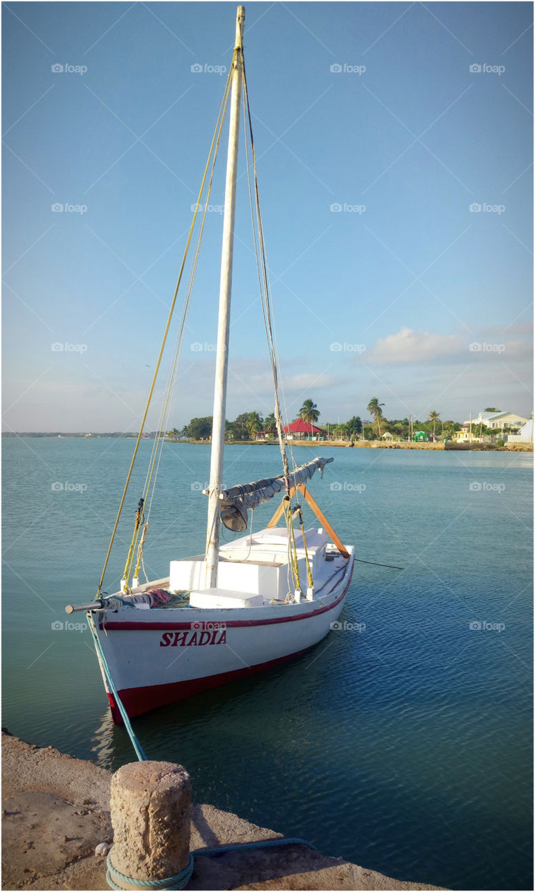 Sailing boat on a pier in Belize to Atatdecer