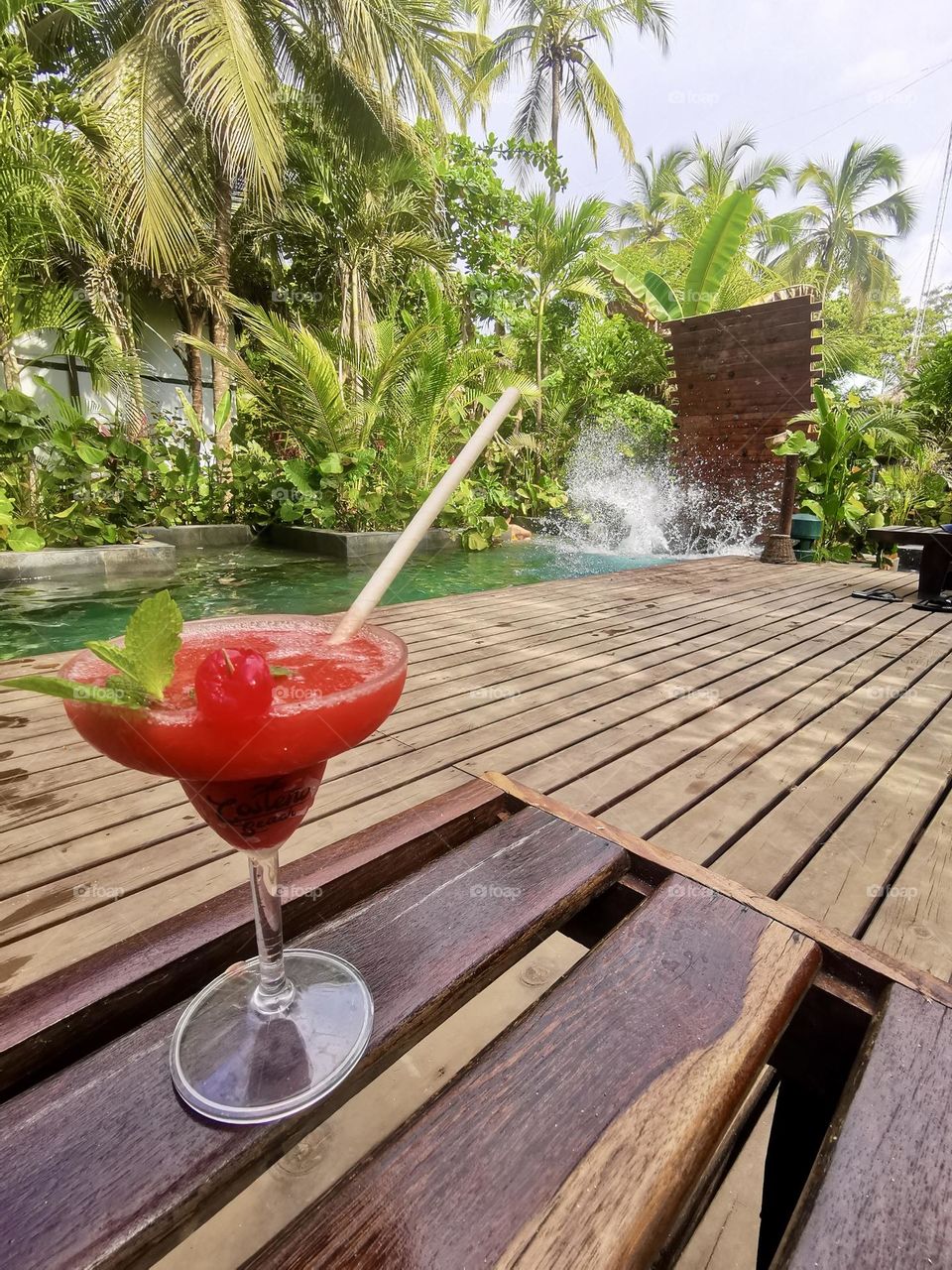 A fruit cocktail in front of the pool