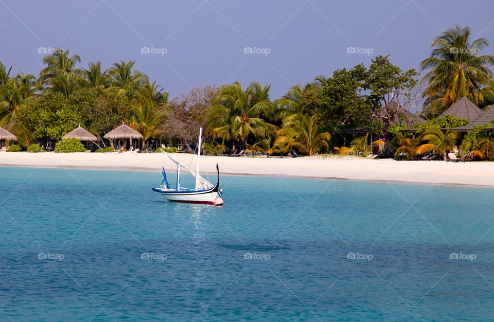 Boat in the island against clear sky