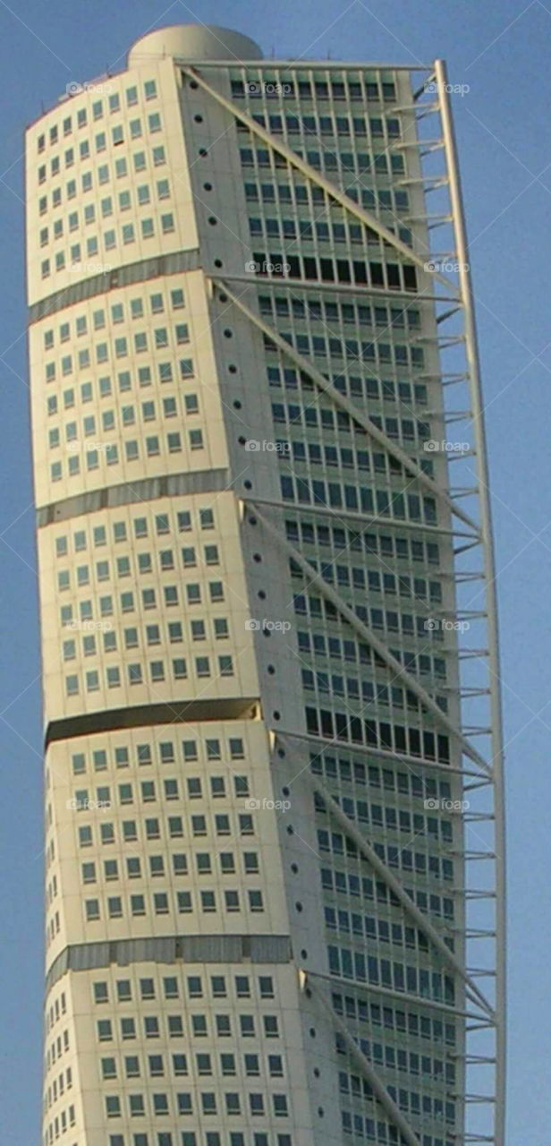 The turning torso in Malmoe 
is 190 meter high. has 147 apartments and 54 floors. ² boyta.  kub tre till kub nio.

 The hole construction twists 90 degrees on its way up.   

architect is Santiago calatrava 
Turning Torso is supposed to look like a human body in a turning movement