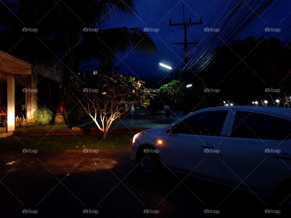 A car with lights on during the night in phuket