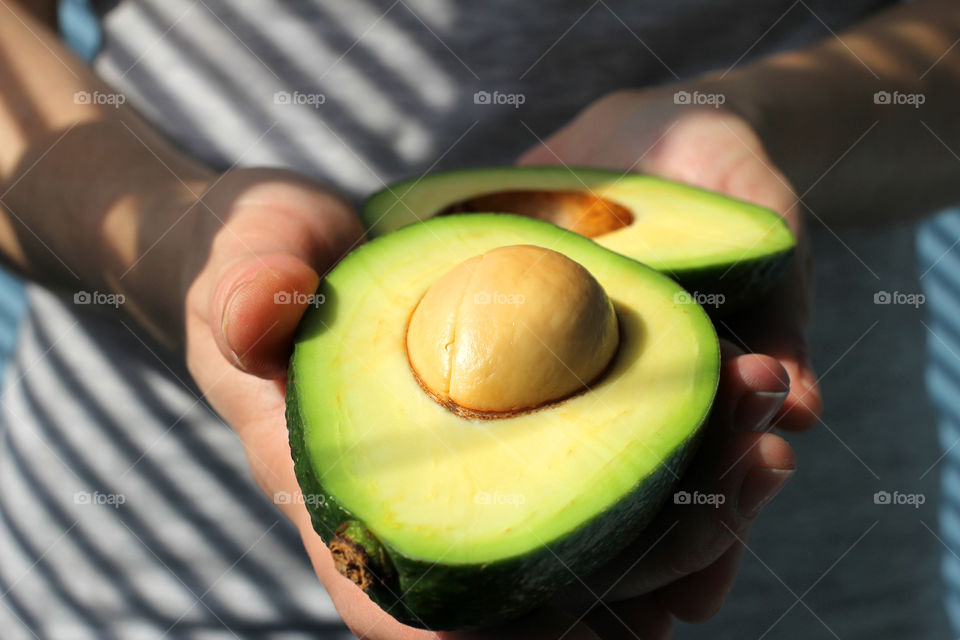 Hands, female hands, avocado in hands, avocado, fruit, food, abstraction, still life