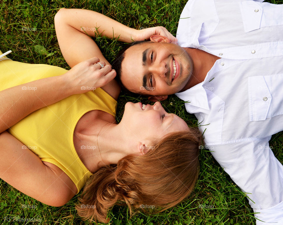 Young couple lying on grass