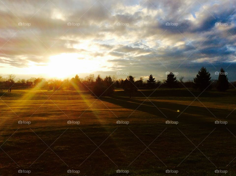 Scenic view of field against sky during sunrise